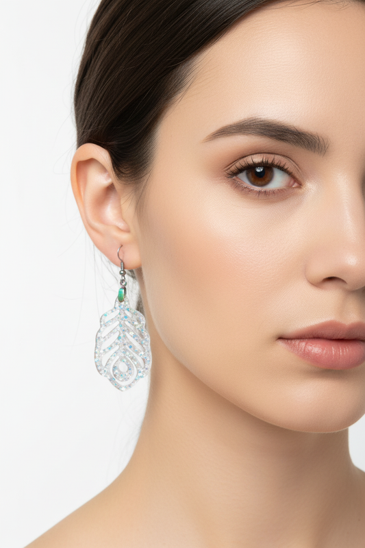 Clear iridescent peacock feather earrings on model